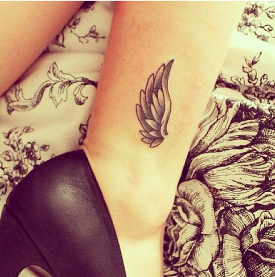 freshly inked wing tattoo on male ankle Stock Photo  Alamy