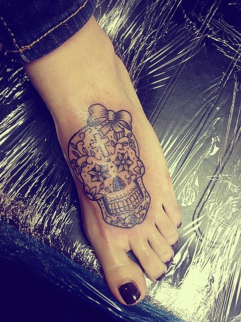 Sugar skull with floral petals and tiny vines drawn on the foot   selfinflicteddowntown tattoo foottattoo sugarskull blackandgrey   Instagram